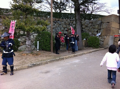 姫路城の前で観光客を出迎える足軽姿のスタッフ